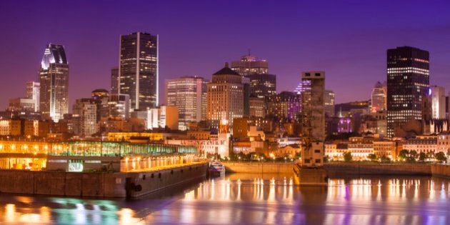 Downtown city skyline at night, showing St. Lawrence River, Montreal, Quebec, Canada