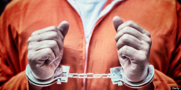 Handcuffed Prisoner in Orange Coveralls