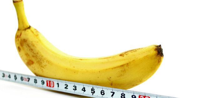 Large banana and measuring tape on a white background