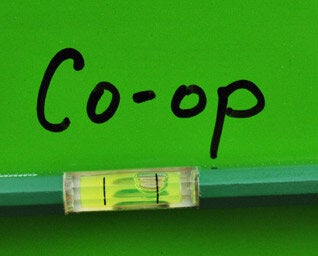 Text: "Co-op" with a level on a green background.