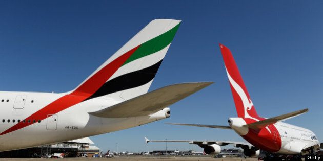Airbus SAS A380-800 aircraft operated by Emirates Airline, left, and Qantas Airways Ltd. stand on the tarmac during a media event in Sydney, Australia, on Thursday, Sept. 6, 2012. Qantas formed an alliance with Emirates to coordinate prices and schedules, while scrapping a similar deal with British Airways, as the carrier tries to reverse losses on long-haul routes. Photographer: Brendon Thorne/Bloomberg via Getty Images