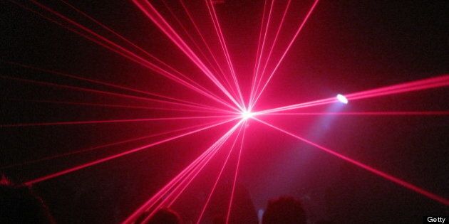 people clubbing with laser lights
