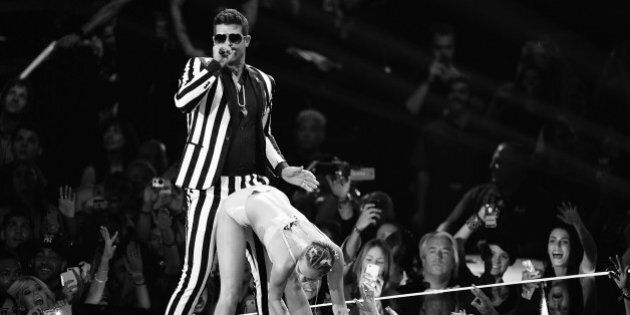 NEW YORK, NY - AUGUST 25: (EDITORS NOTE: Image has been converted to black and white) Miley Cyrus and Robin Thicke perform on stage during the 2013 MTV Video Music Awards at the Barclays Center on August 25, 2013 in the Brooklyn borough of New York City. (Photo by Andrew H. Walker/Getty Images for MTV)