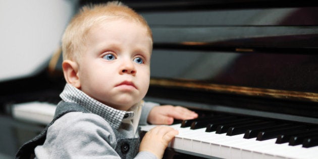 small genius sitting near piano - indoors shoot