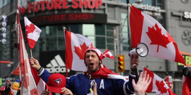 TORONTO, ON- FEBRUARY 23 - Canadian fans celebrate the men's hockey Olympic gold medal by shutting down the intersection at Yonge-Dundas Square In Toronto. February 23, 2014. (Steve Russell/Toronto Star via Getty Images)