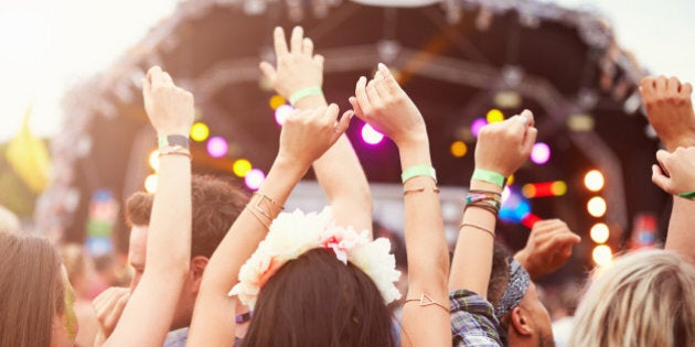 Audience with hands in the air at a music festival