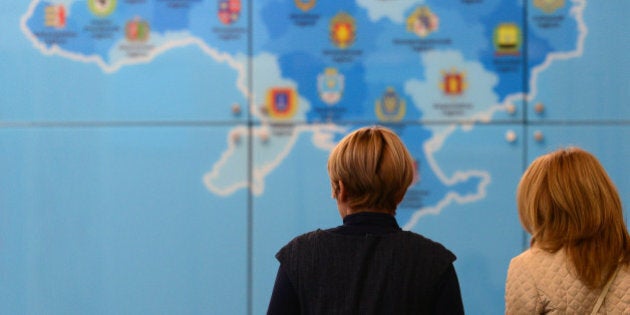 Women walk past a tourist map of the Ukraine at the Ukraine stand of the ITB International Travel Trade Fair in Berlin March 4, 2014. The ITB open from March 5 to 9, 2014. AFP PHOTO / JOHN MACDOUGALL (Photo credit should read JOHN MACDOUGALL/AFP/Getty Images)