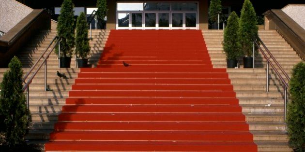Festival hall and pavilion for annual film festival showings. The red carpet leading up steps for the Cannes Film Festival celebrity event.