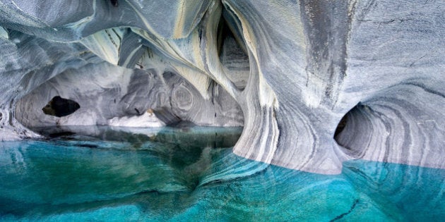 PATAGONIA, CHILE - UNDATED: (EXCLUSIVE COVERAGE) A general view of the Marble Cathedral on Lake Carrera in Patagonia, Chile. Welcome to the Marble Cathedral - a natural wonder that could be the world¿s most beautiful cave network. Like an azure temple created by nature, the walls of this network of water-filled marble caverns show just how magnificent the precious geography of our planet can be. Visitors to the water-sculptured blue caverns experience an incredible display of light, which is so rich thanks to the way the incredible sky of Patagonia is reflected into the waters of South America¿s second largest freshwater lake, General Carrera. The light from the water bounces into the caverns and strikes the strangely carved marble walls, creating this enchanting lightshow. The incredible set of pictures has been captured by talented landscape photographer and environmentalist, Linde Waidehofer, 67, from Colorado in the USA. ¿It is the water that formed the sinuous shapes of the marble walls - these waters are magic¿ explained Linde in her book on the caverns, ¿Blue Light¿. To reach this remote place located in the far southern tip of Chile visitors must fly from the capital, Santiago 1,200 miles to the nearest large city, Coyhaique and then drive 130 miles on challenging dirt roads south to the lake. (Photo by Linde Waidehofer/Barcroft Media/Getty Images)