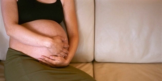 Pregnant Woman Sitting on Sofa