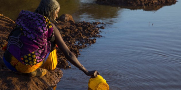 YABELO, ETHIOPIA - MARCH 05: Borana tribe woman filling jerricans in a water reservoir used for animals, Oromia, Yabelo, Ethiopia on March 5, 2017 in Yabelo, Ethiopia. (Photo by Eric Lafforgue/Art In All Of Us/Corbis via Getty Images)