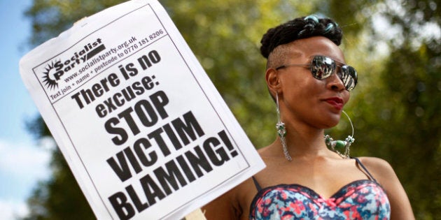 A woman holds a banner as she takes part in a 'slut walk' in London on September 22, 2012 to protest against the police and courts' denial of justice for rape victims. AFP PHOTO / JUSTIN TALLIS (Photo credit should read JUSTIN TALLIS/AFP/GettyImages)