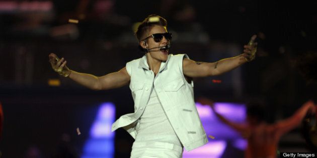 Canadian pop star Justin Bieber, 19-years-old, performs in front of a crowd of 15,000 fans at the Sevens Stadium in Dubai, on May 4, 2013. This is Bieber's first visit to the UAE. AFP PHOTO/KARIM SAHIB (Photo credit should read KARIM SAHIB/AFP/Getty Images)