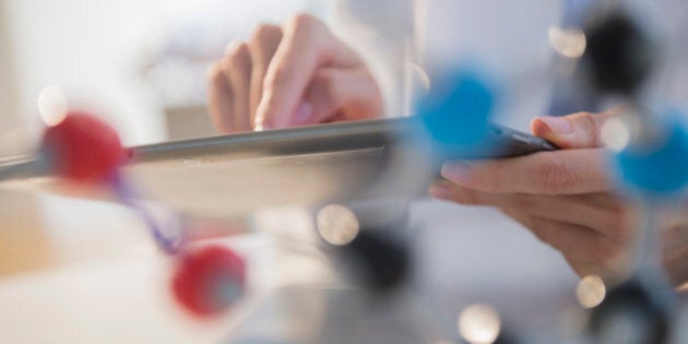 Mixed race scientist using digital tablet in laboratory