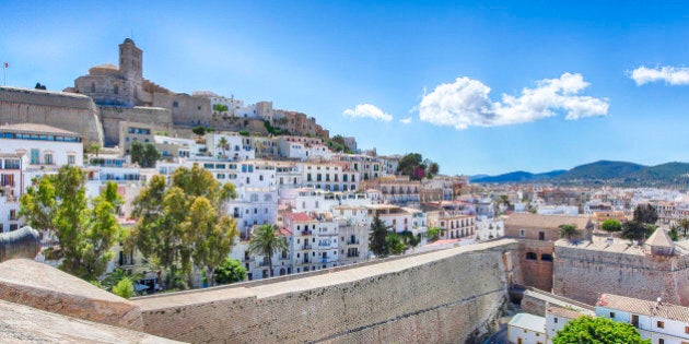 Sunny Panorama with a blue sky and few white clouds from the old town of Ibiza (old city of Eivissa) in Spain (Balearic Islands). Photo taken from the stone wall surrounding the city with a view of the Cathedral.