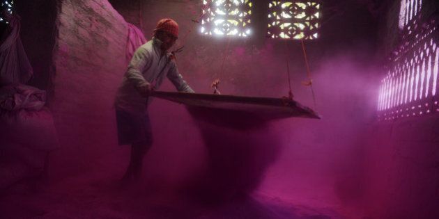 An Indian labourer sifts coloured powder, known as 'gulal', to be used during the forthcoming spring festival of Holi, inside a factory at Fulbari village on the outskirts of Siliguri on March 9, 2014. Holi, the popular Hindu spring festival of colours is observed in India at the end of the winter season on the last full moon of the lunar month and will be celebrated on March 16 this year. AFP PHOTO /Diptendu DUTTA (Photo credit should read DIPTENDU DUTTA/AFP/Getty Images)