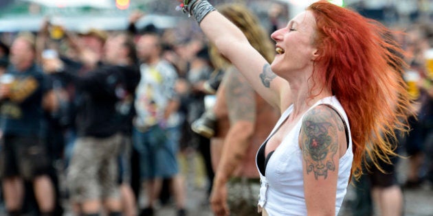 WACKEN, GERMANY - AUGUST 03: A festival goer enjoys the Wacken Open Air heavy metal music fest on August 3, 2012 in Wacken, Germany. Approximately 75,000 heavy metal fans from all over the world have descended on the north German village of 1,800 residents for the annual three-day fest. (Photo by Patrick Lux/Getty Images)