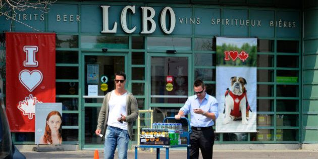 TORONTO, ON - JULY 13: People leaving the LCBO as beer sales have spiked during the hot and dry weather.......shots of people leaving the LCBO with there wares on Queens Quay at Cooper st. (Colin McConnell/Toronto Star via Getty Images)