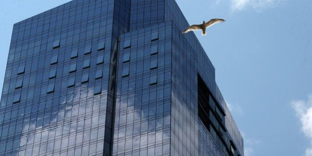 BOSTON, MA - JULY 20: A bird flies by the new Millennium Tower, located on the corner of Summer and Washington Streets at Downtown Crossing in Boston, July 20, 2016. (Photo by David L. Ryan/The Boston Globe via Getty Images)