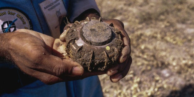 Sri Lankan minesweeper holding a TS-50 Anti-Personnel landmine in a mine field in Jaffna, Northern district.