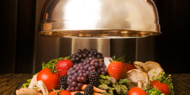 Silver lid lifted to show tray full of vegetable and fruit