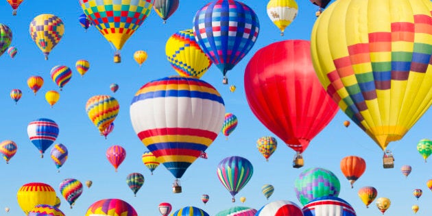 Hot air balloons floating in blue sky