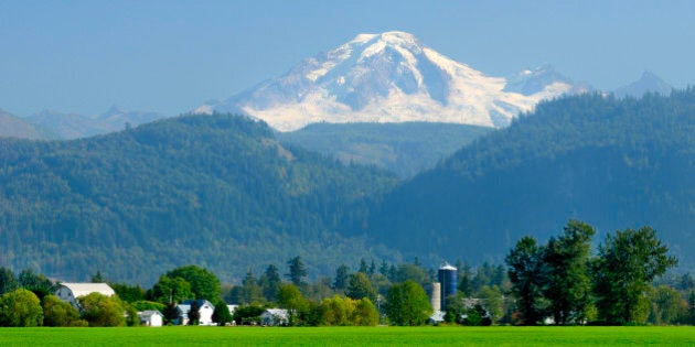 Farms, barns and silo's with Mt. Baker in the background, Abbotsford, British Columbia, Canada.
