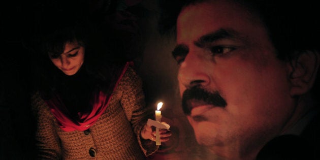Pakistani civil rights activists light candles during a ceremony on the site of attack on slain Pakistani minority affairs minister Shahbaz Bhatti in Islamabad on March 3, 2011. Pakistan announced three days of national mourning and vowed 'fool-proof' security after a Christian government minister who decried Islamic blasphemy laws was gunned down. AFP PHOTO/Farooq NAEEM (Photo credit should read FAROOQ NAEEM/AFP/Getty Images)