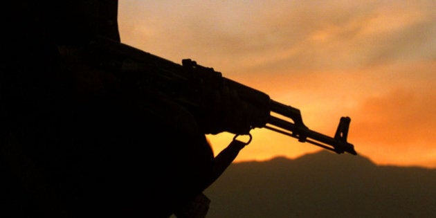 A Northern Alliance fighter armed with an AK-47 assault rifle scansTaliban positions at a front line observation post in Bakhshi i Khelsome 25 km north of the Afghan capital Kabul October 26, 2001. TheNorthern Alliance, a mix of mostly ethnic Uzbek and Tajik fighters inthe north, is viewed with suspicion and enmity by ethnic Pashtuns, whooperate in other areas. REUTERS/Yannis BehrakisYB/WS