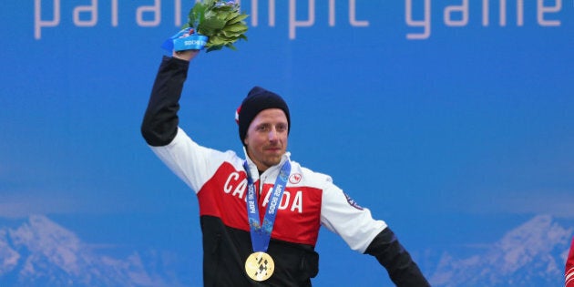 SOCHI, RUSSIA - MARCH 15: Gold medalist Josh Dueck of Canada celebrates at the medal ceremony for men's Super Combined Sitting on day eight of the Sochi 2014 Paralympic Winter Games at Laura Cross-country Ski & Biathlon Center on March 15, 2014 in Sochi, Russia. (Photo by Ronald Martinez/Getty Images)