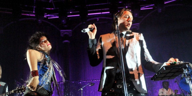 LONDON, ENGLAND - NOVEMBER 11: Win Butler and Regine Chassagne of Arcade Fire perform live on stage, during a tour billed under the name 'The Reflektors', at The Roundhouse on November 11, 2013 in London, England. (Photo by Jim Dyson/Getty Images)