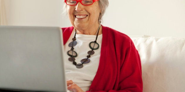 Elderley woman using tablet and laptop computers