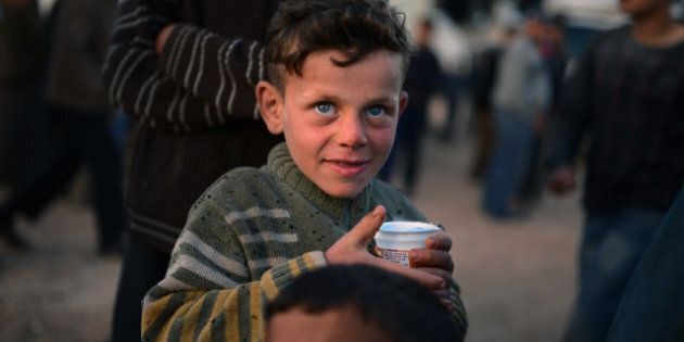 A Syrian boy holds a cup in the refugee camp of Al-Salam in the northern province of Aleppo along the Turkish border on April 9, 2013. The United States is mulling ways to step up support for the Syrian opposition, a top US official said, as US Secretary of State John Kerry and G8 ministers were to meet rebel leaders. AFP PHOTO / DIMITAR DILKOFF (Photo credit should read DIMITAR DILKOFF/AFP/Getty Images)
