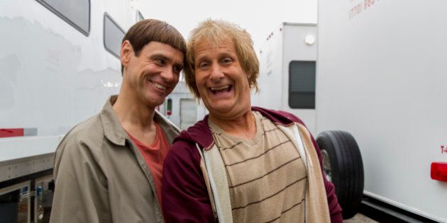 This image released by Universal Studios shows Jim Carrey, left, and Jeff Daniels in character as Lloyd Christmas and Harry Dunne, respectively, on the set of