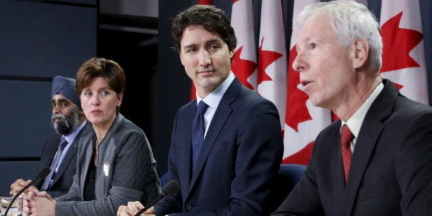 Canada's Prime Minister Justin Trudeau (2nd R) listens to Foreign Minister Stephane Dion (R) speak during a news conference in Ottawa, Canada, February 8, 2016. Also pictured are Defence Minister Harjit Sajjan (L) and International Development Minister Marie-Claude Bibeau. REUTERS/Chris Wattie