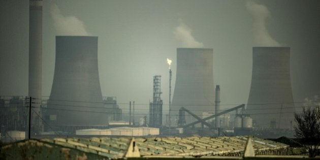 Smokes spread from the cooling towers of the synthetic fuel plant in Secunda, on August 26, 2015. Secunda is one of the largest coal liquefaction plants in the world producing petroleum-like synthetic crude oil from coal. AFP PHOTO / MUJAHID SAFODIEN (Photo credit should read MUJAHID SAFODIEN/AFP/Getty Images)