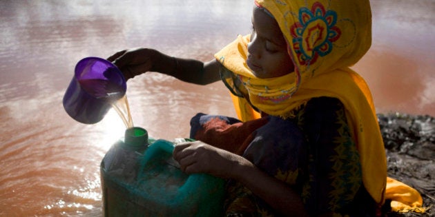 Densa Tadicha, 10, collects water from a pond used by animals at El-Ley village in the drought affected region of Moyale June 12, 2009. The consumption of contaminated water from shallow wells and ponds meant for cattle, poor nutrition and unsafe hygiene practices have led to an outbreak of cholera and acute watery diarrhoea (AWD) which has left 25 people dead and 1,300 needing emergency medical care in the Moyale region of Ethiopia and Kenya, home to some half a million people. The International Federation of Red Cross and Red Crescent Societies (IFRC) says it needs some 100 million Swiss francs to prevent conflict, famine and epidemics as well as restore the livelihoods of 2.5 million people in the Horn of Africa. Picture taken June 12, 2009. REUTERS/Irada Humbatova (ETHIOPIA SOCIETY CONFLICT IMAGES OF THE DAY HEALTH)