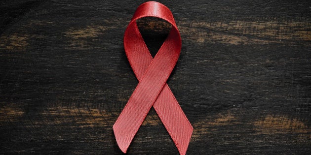 red aids ribbon on old wood...