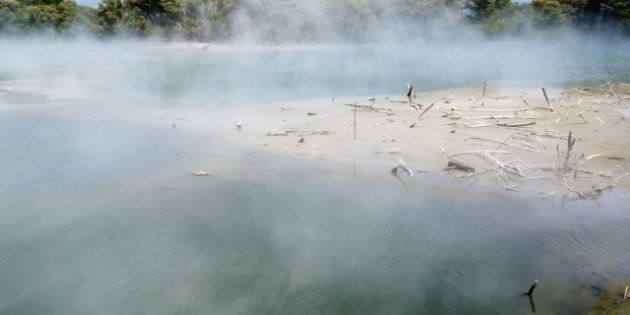 steaming volcanic hot spring in ...