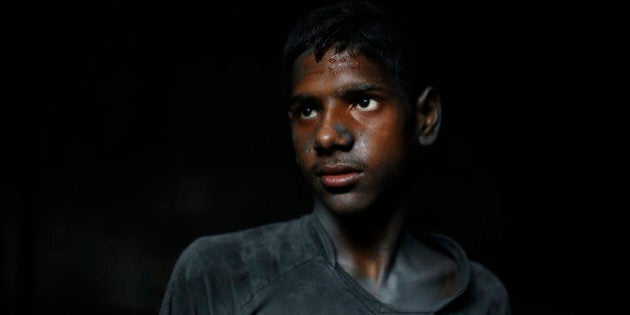 In this Sunday, June 12, 2016, photo, Ridoy, 11, poses for a portrait as he works at a factory that makes metal utensils in Dhaka, Bangladesh. The World Day Against Child Labor, which was initiated in 2002 by the International Labor Organization to highlight the plight of child laborers, is observed across the world on June 12. (AP Photo/A.M. Ahad)