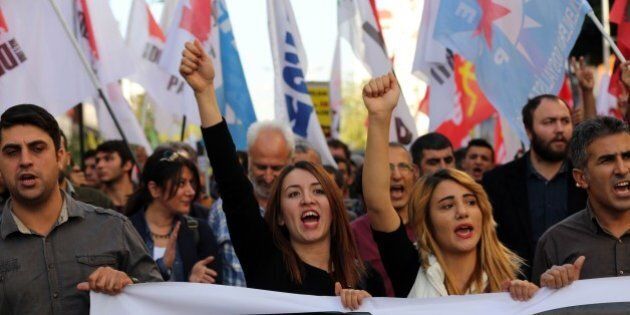 Members of Turkish leftist movements shout slogans during an anti-G20 protest in Antalya, on November 15, 2015. Leaders from the world's top 20 industrial powers meet in Turkey from November 15 seeking to overcome differences on a range of issues including the Syria conflict, the refugee crisis and climate change. AFP PHOTO / ADEM ALTAN (Photo credit should read ADEM ALTAN/AFP/Getty Images)