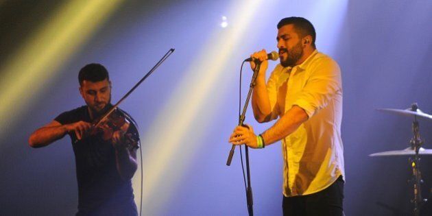 Hamed Sinno (R) and Haig Papazian of Lebanese alternative rock band Mashrou' Leila perform on stage at the 39th 'Le Printemps de Bourges' rock and pop music festival in Bourges, central France, on April 26, 2015. AFP PHOTO / GUILLAUME SOUVANT (Photo credit should read GUILLAUME SOUVANT/AFP/Getty Images)