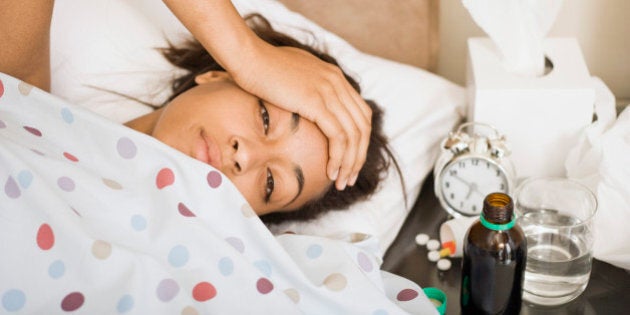 Sick woman lying in bed