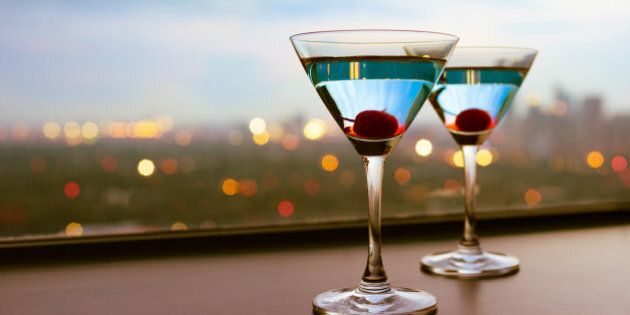 Martini cocktail glasses with a city view.