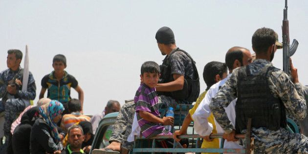 Families from Fallujah flee their homes during fighting between Iraqi security forces and Islamic State group during a military operation to regain control the city, , 40 miles (65 kilometers) west of Baghdad, Iraq, Wednesday, June 1, 2016. The U.N. children's fund has issued a stark warning to Iraqi troops and Islamic State militants in the battle for Fallujah to spare the children, the most vulnerable among tens of thousands of civilians trapped in the city west of Baghdad (AP Photo/Anmar Khalil)
