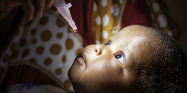 An East African baby receiving a Polio vaccine.