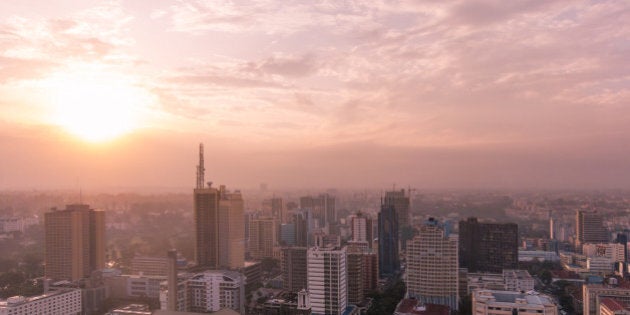 View over Nairobi central business district. Photo has a pink and purple tone. English-style clock tower of Kenya's Parliament House visible (lower middle).