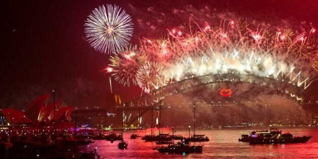 Spectator boats in Sydney Harbour look on as New Year's Eve fireworks erupt over the Sydney Harbour Bridge on January 1, 2013. Sydney kicked off a wave of dazzling firework displays welcoming in 2013, from Dubai to Moscow and London, with long-isolated Yangon joining the global pyrotechnics for the first time. AFP PHOTO/MANAN VATSYAYANA (Photo credit should read MANAN VATSYAYANA/AFP/Getty Images)