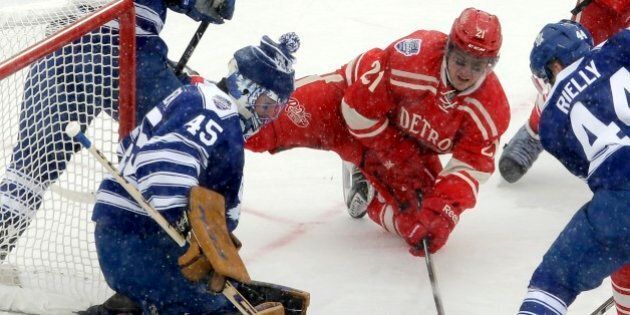 Toronto Maple Leafs goalie Jonathan Bernier (45) blocks a shot by Detroit Red Wings left wing Tomas Tatar (21), of the Czech Republic, during the first period of the Winter Classic outdoor NHL hockey game at Michigan Stadium in Ann Arbor, Mich., Wednesday, Jan. 1, 2014. (AP Photo/Carlos Osorio)
