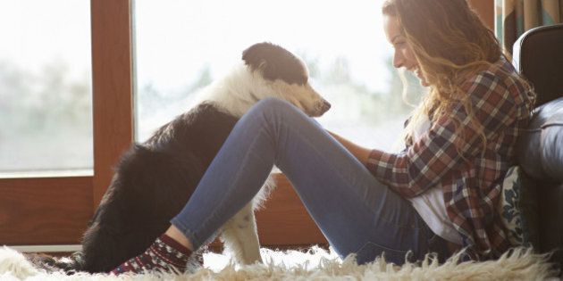 Profile of woman sitting in lounge with dog.